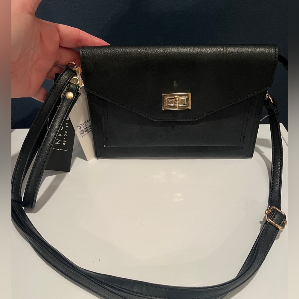 Isabelle wristlet/crossbody in black with gold hardware.